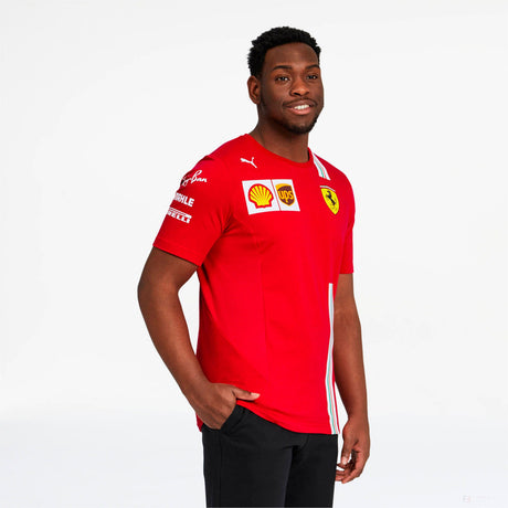 Model wearing red Ferrari polo shirt with logos