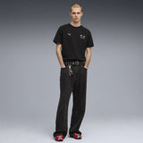 Black T-shirt worn standing with other clothing.